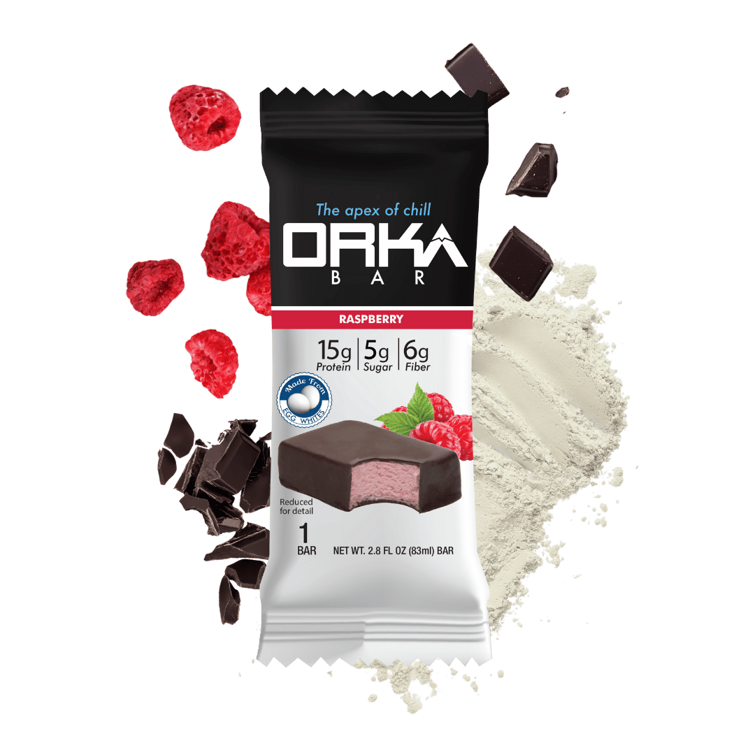 Orka Bar raspberry flavor packaging with chocolate pieces and raspberries on a green background