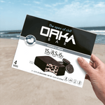 Oaka Bar packaging held by a hand with a beach background