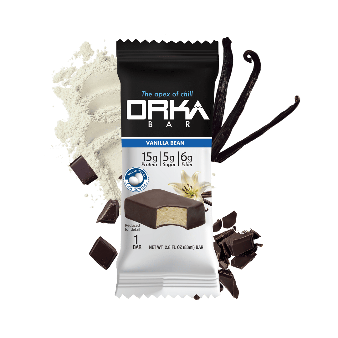Orka Bar vanilla bean flavor packaging with vanilla beans and chocolate pieces on a green background